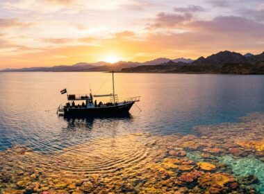 Remote Red Sea dive boat near reef at sunrise in Sudan